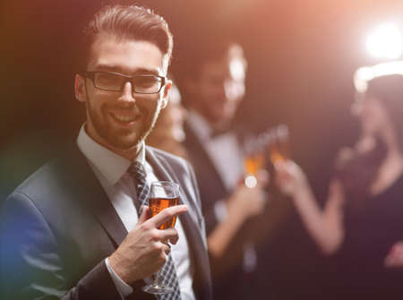 elegant man raising his glass with the toastの写真素材