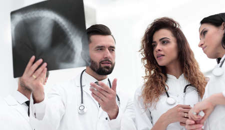 group of medical workers looking at patients x-ray filmの写真素材
