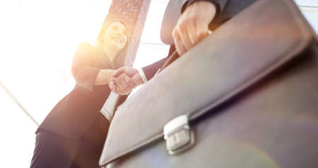 Close up of businessman and businesswoman shaking handsの写真素材