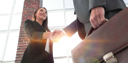 Close up of businessman and businesswoman shaking handsの写真素材