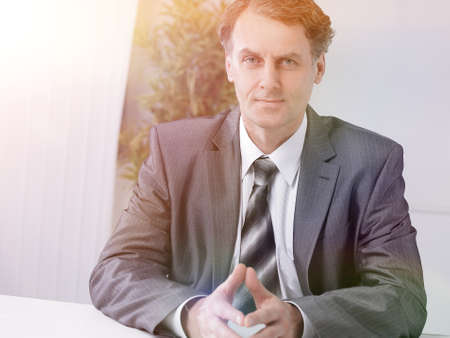 Portrait of businessman sitting at the deskの写真素材