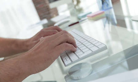 close-up of an employee typing on a personal computer keyboard.の写真素材