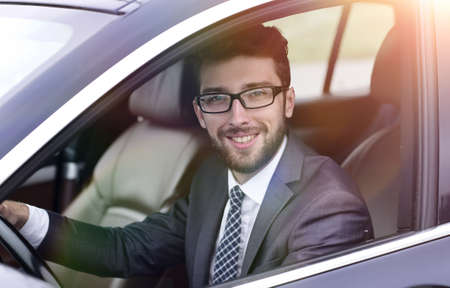 businessman in suit driving his luxurious car.の写真素材