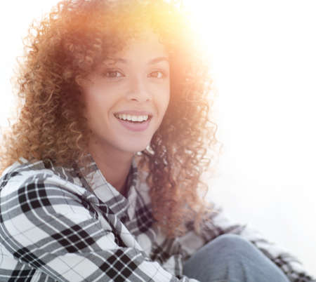 young woman with curly hair in a plaid shirt