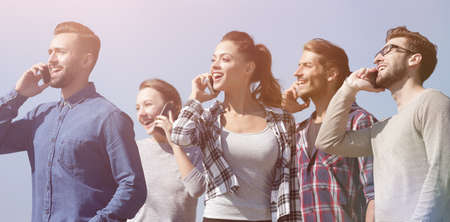 closeup of a group of young people with smartphones.の写真素材