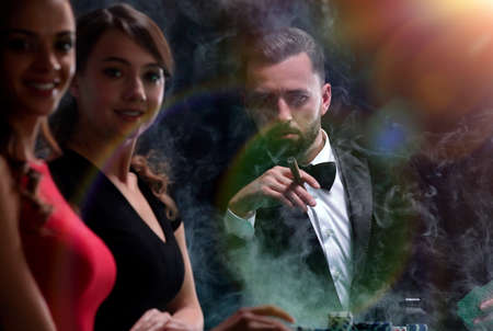 Upper class friends gambling in a casino.の写真素材