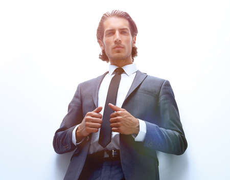 businessman is leaning on a white wallの写真素材