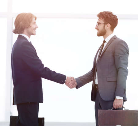 Two young businessmen greetの写真素材