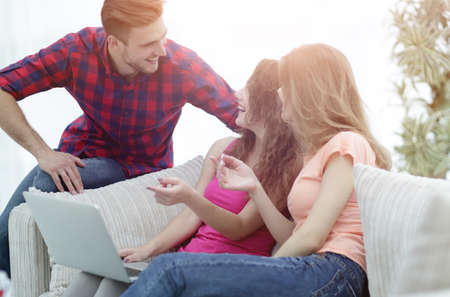 group of students talking,sitting on the couch.