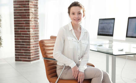 successful young business woman sitting at the desk.