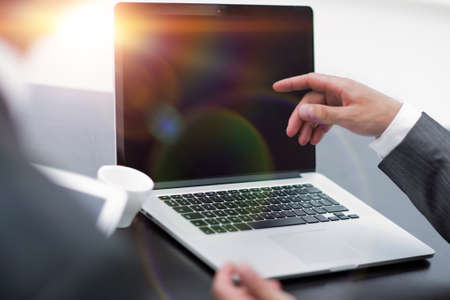 closeup. business colleagues discussing information with a laptop.