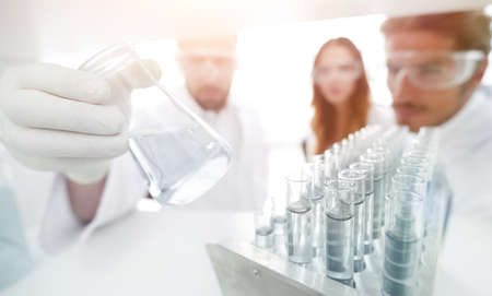 closeup.a group of scientists studying the liquid in the glassの写真素材