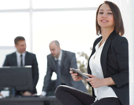 business woman with tablet computer in the background of the officeの写真素材