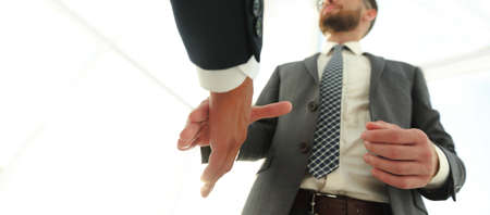 Two  business men going to make handshakeの写真素材