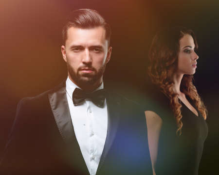 gentleman with his girl posing in the studioの写真素材