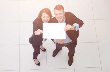 businessman and business woman with blank sheetの写真素材