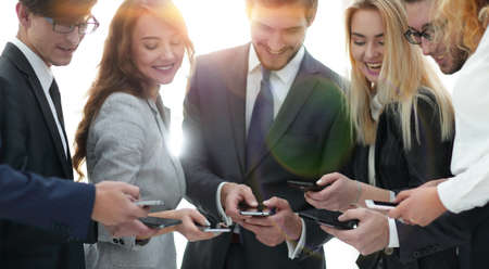 Close up businessman and woman using smart phoneの写真素材