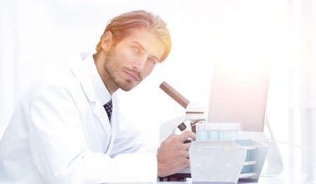 Male Chemist Scientific Reseacher using Microscope in Laboratoryの写真素材