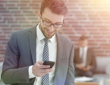 businessman reading text message on smartphoneの写真素材