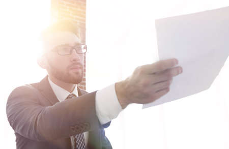 Image of business man holding paperの写真素材