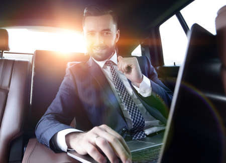 Confident businessman sitting in carの写真素材