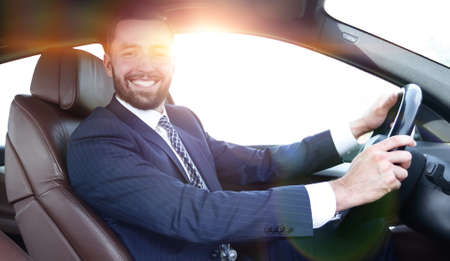 portrait of confident businessman driving a carの写真素材