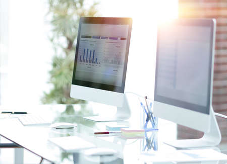 close-up of the screens of personal computers on a modern workplace in the office.の写真素材