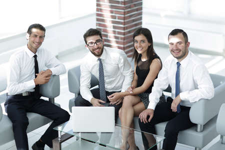 successful business team sitting in office lobbyの写真素材