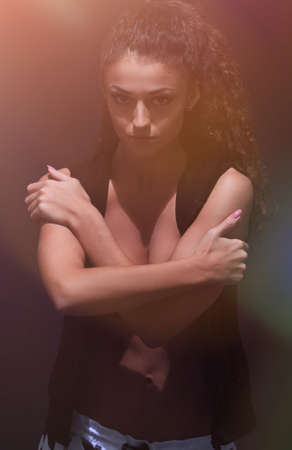 young woman dancing hip-hop in studio.
