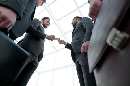 businessman handing business card to the partner.の写真素材