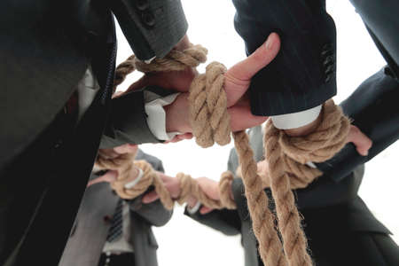 closeup.business team holding rope forming a circleの写真素材