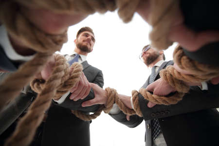 closeup.business team holding strong rope.の写真素材