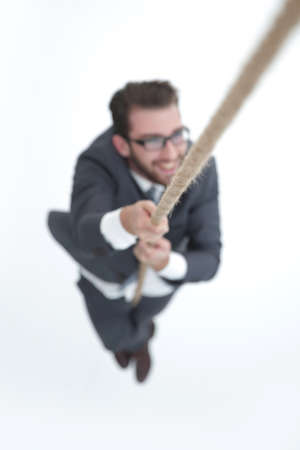 successful businessman climbing the ropeの写真素材