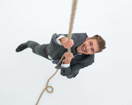 successful businessman climbing the ropeの写真素材
