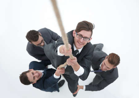 business team helping the leader to climb the ropeの写真素材