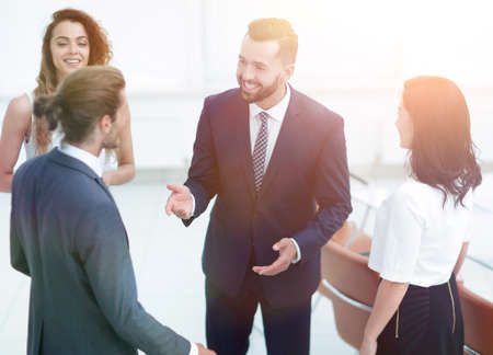 business team talking, standing in officeの写真素材