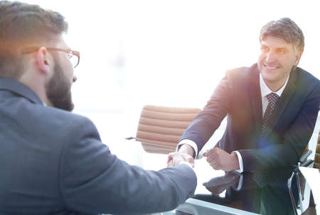Handshake across the table of financial partnersの写真素材