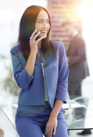 Young businesswoman with mobilephoneの写真素材