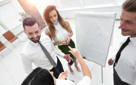 business team standing in front of a flipchart.の写真素材