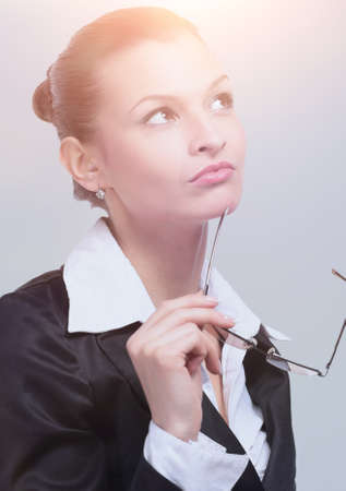 Thoughtful business woman looking confident . Isolated on grayの写真素材
