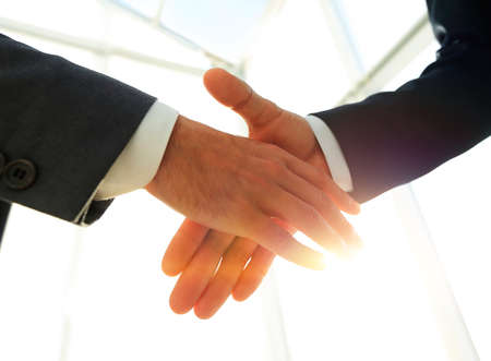 Two  business men going to make handshakeの写真素材