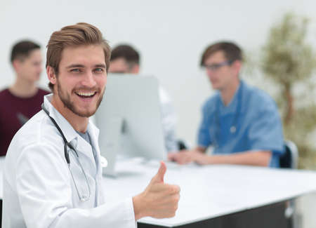 smiling doctor showing thumb upの写真素材