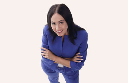 Beautiful woman in blue suit smiling on white background