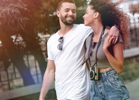 Cheerful young couple walking on urban streetの写真素材