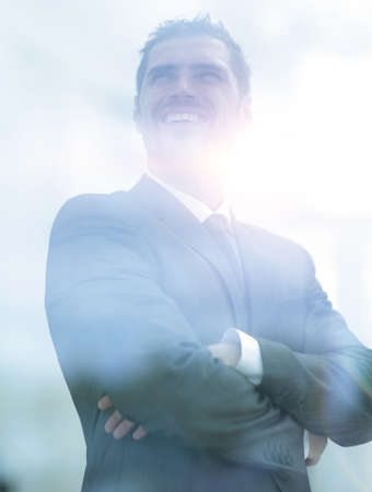 from behind the glass. modern businessman looks out the window oの写真素材