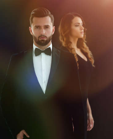 gentleman with his girl posing in the studioの写真素材