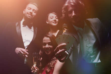 Upper class friends gambling in a casino.の写真素材