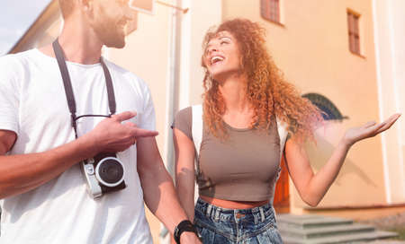 Couple of tourists look at each other and walking