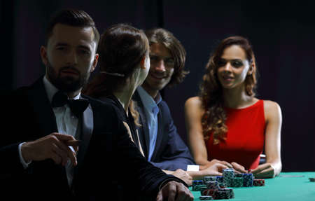 Man with cigar looking up from poker game in casinoの写真素材