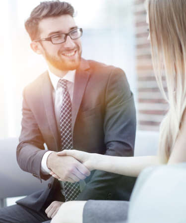 close-up of a manager shakes hands with a regular customer.の写真素材